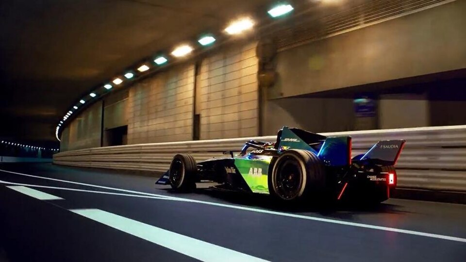 A Formula E Gen3 single-seater, from the back, drives through the tunnel of the Circuit de Monaco.