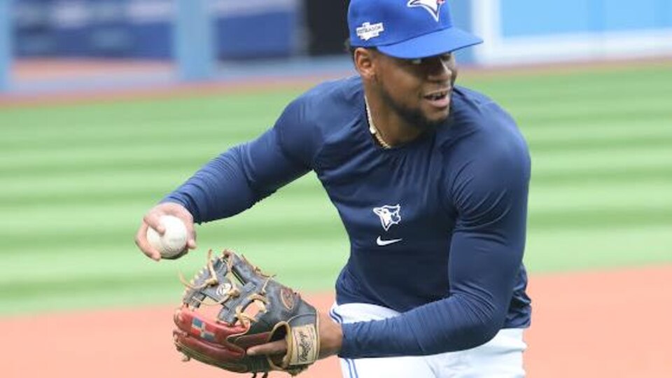 Le joueur de baseball Otto Lopez s'apprête à lancer une balle.