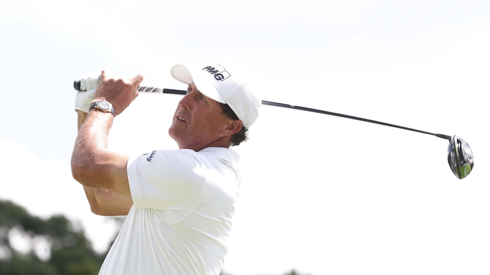 He watches his tee shot.