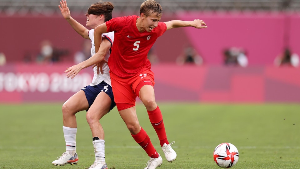 Deux athlètes se disputent le ballon pendant un match de soccer féminin.