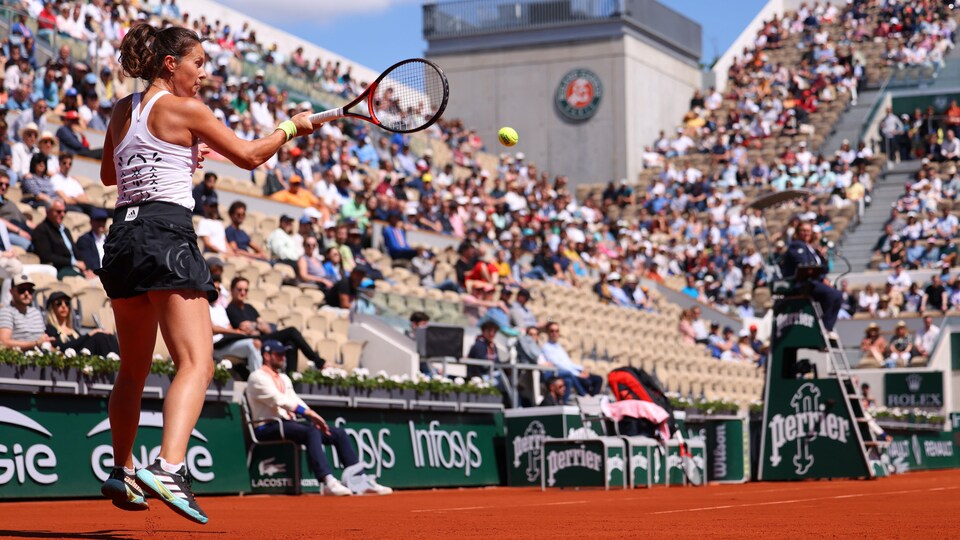 He returns a serve from baseline.