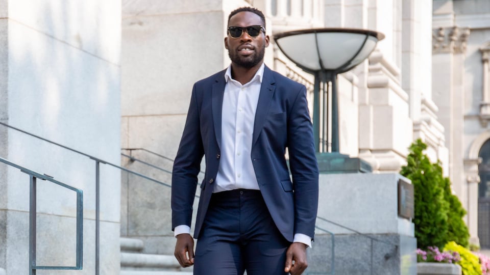 Photo of Xavier Jourson wearing a suit and posing for the camera