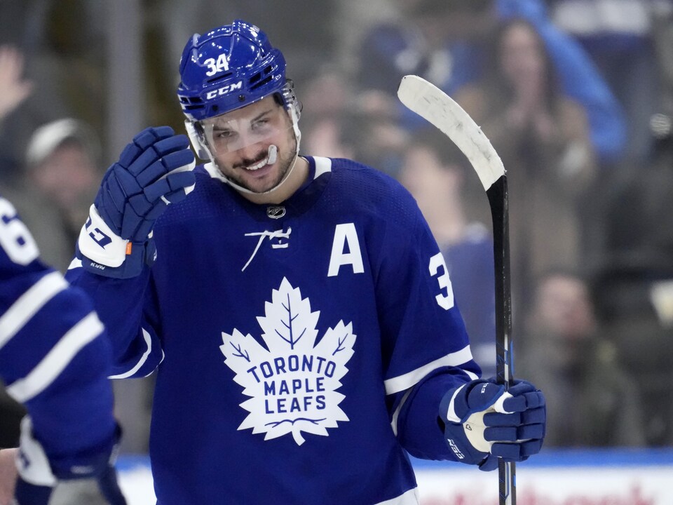 A hockey player smiles.