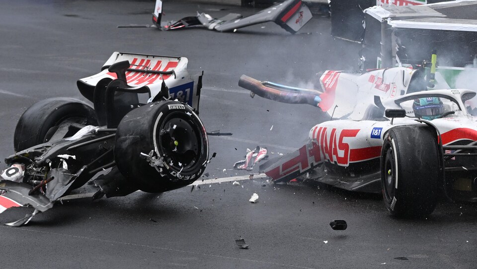 An F1 single-seater is split in half after leaving the track.  