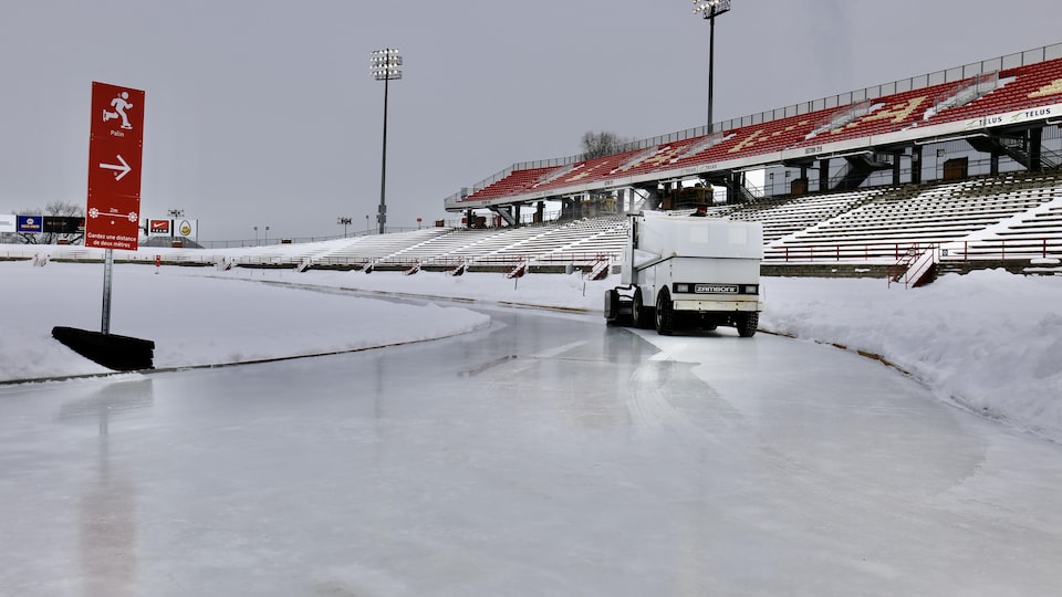 Zamboni runs over the ring in the middle of the soccer field. 