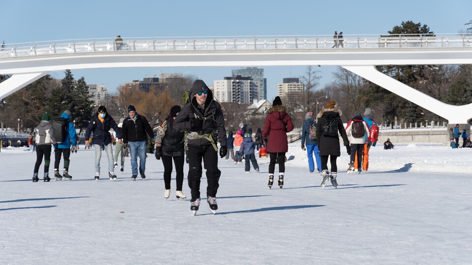 Des dizaines de personnes patinent sur le canal Rideau.