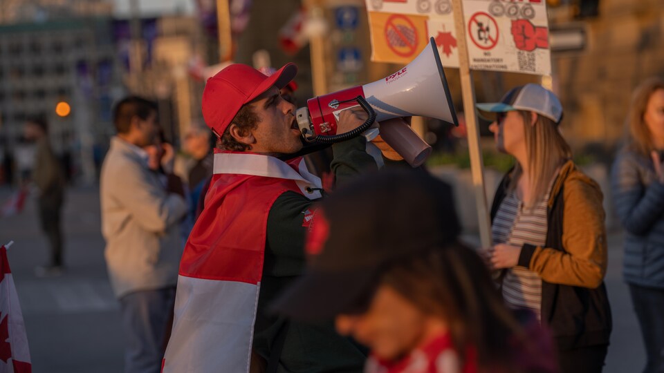 A protester speaks into a megaphone.
