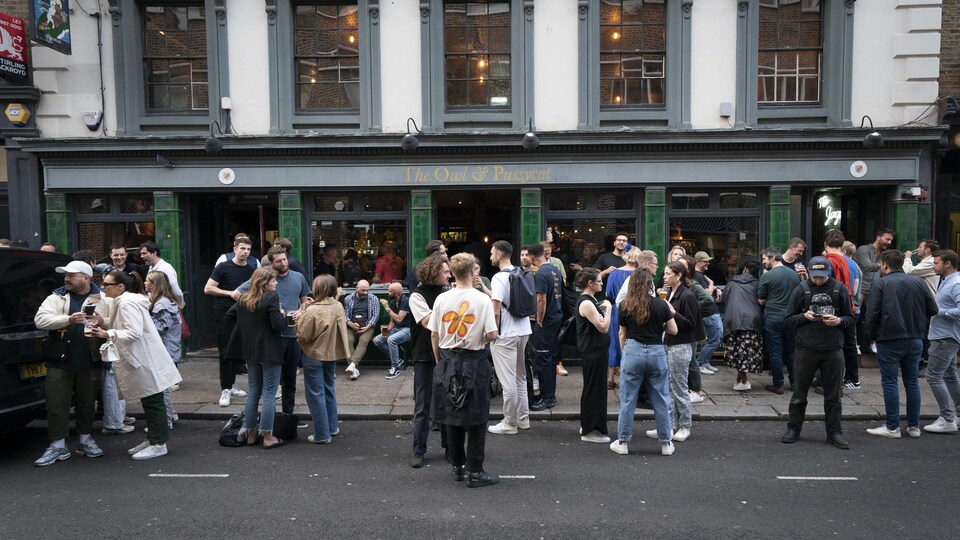 People drink beer in the street.