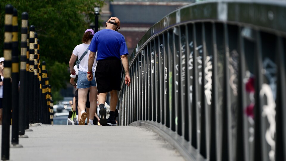 Des gens traversent un pont.
