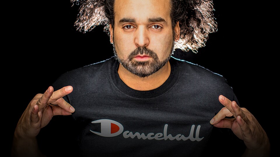 L'artiste met en évidence son chandail sur lequel il est écrit Dancehall.