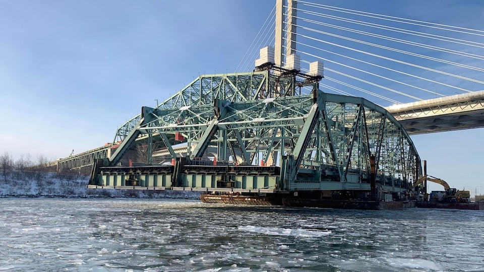 Une barge transporte une section du vieux pont Champlain sous l'actuel pont Samuel-De Champlain.