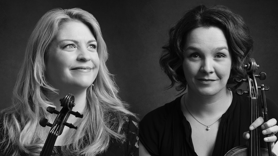Deux femmes côte à côte tiennent un violon.