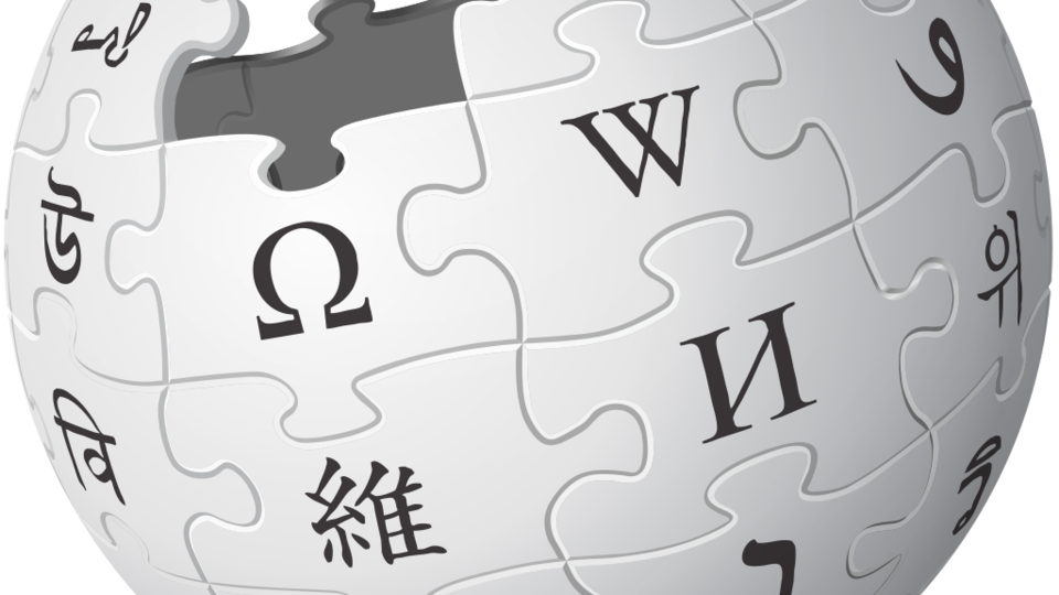Une sphère composée de morceaux de casse-tête affichant des lettres et des symboles provenant de différents types d'écriture.