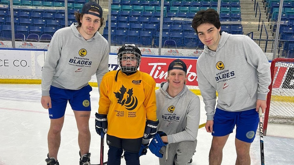 Blades players with a young skater. 