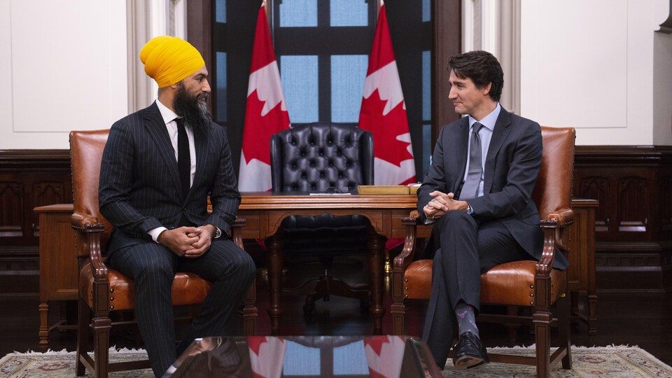 Le chef du NPD, Jagmeet Singh, regarde dans la direction du premier ministre Justin Trudeau. Les deux hommes sont assis sur une chaise lors d'une rencontre dans un bureau situé sur la colline du Parlement à Ottawa, le jeudi 14 novembre 2019. 