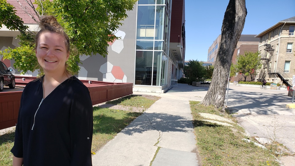 Janique Fillion, étudiante à la maîtrise en Physiothérapie (M.A.), Université du Manitoba, se trouve sur un trottoir près d'une rue