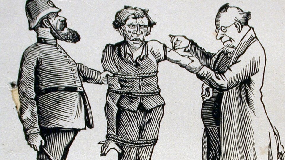 Un homme ligoté se fait vacciner de force.