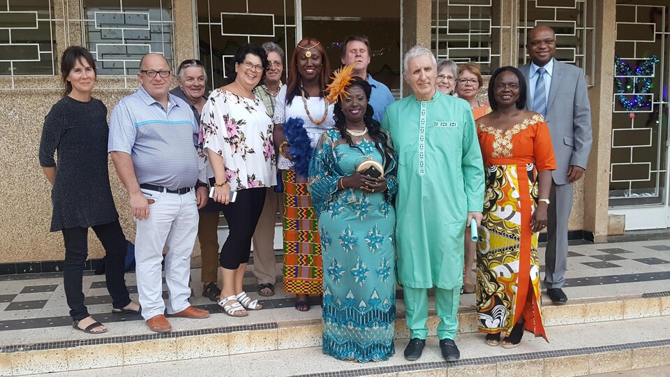 Une dizaine de personnes sont sur un parquet d'une mairie. Elles célèbrent un mariage civil.