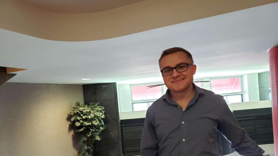 Mathieu Jubinville, jeune citoyen passionné de la politique, debout au premier étage, près de l'entrée principale de Radio-Canada Manitoba