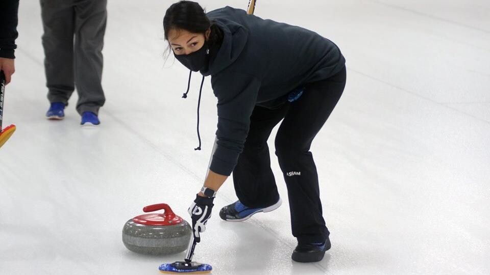 Hey-Sem Won is on the ice, dressed in black, in action.