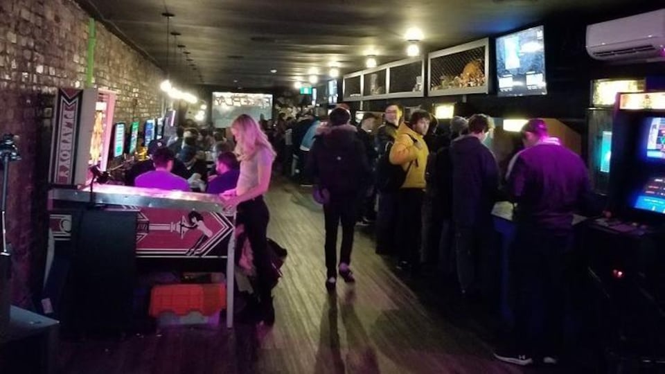 Des partisans de jeux vidéos dans le bar Freeplay, à Toronto.