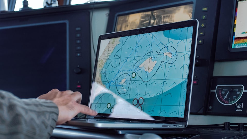 Une personne consulte une carte marine sur un ordinateur.
