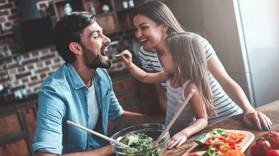 Une famille a du plaisir dans une cuisine.