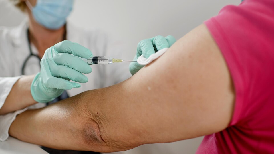 Une personne reçoit une dose de vaccin contre la COVID-19.
