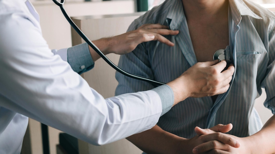 Un médecin utilise un stéthoscope pour écouter le rythme cardiaque du patient.