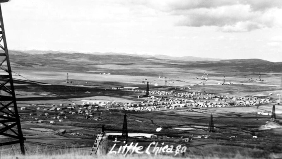 Une ancienne photo d'une petite ville vue de loin.
