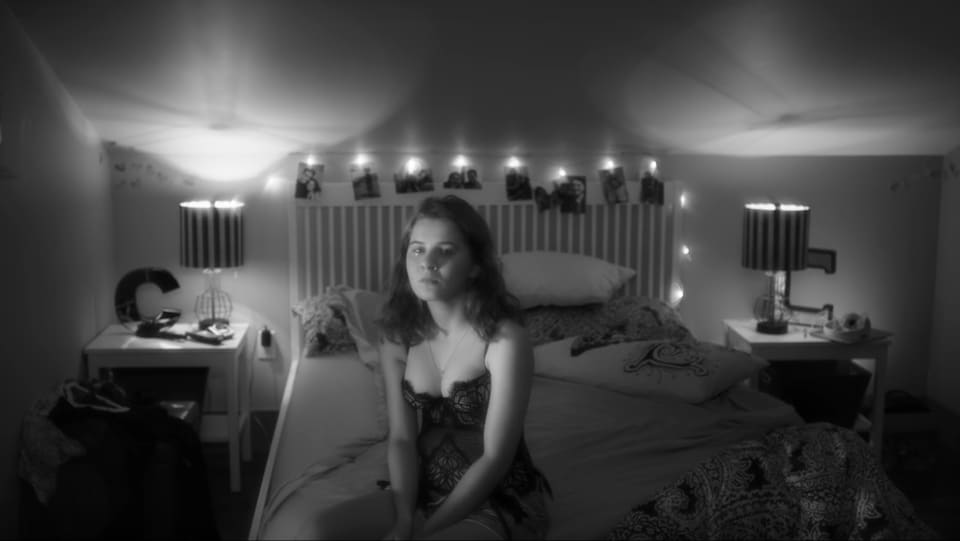 Une jeune femme en nuisette sur son lit