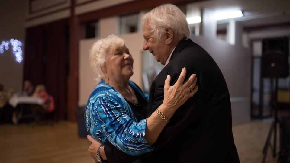 An old couple is dancing.