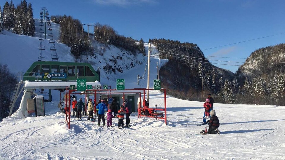Des skieurs font la file pour prendre le remonte-pente au mont de la Station Gallix.