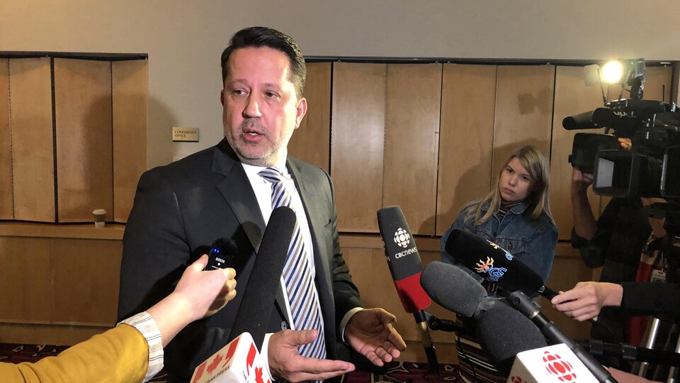 TJ Burke speaks to reporters.