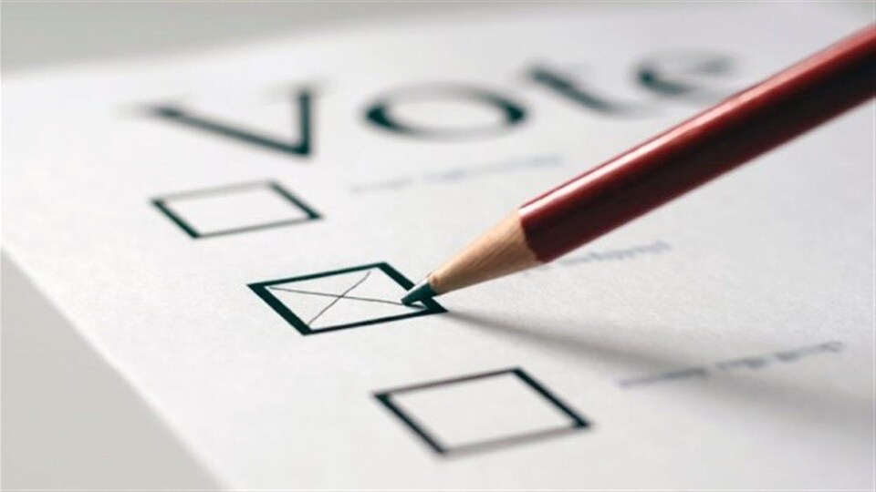 Un crayon trace une croix sur un bulletin de vote.