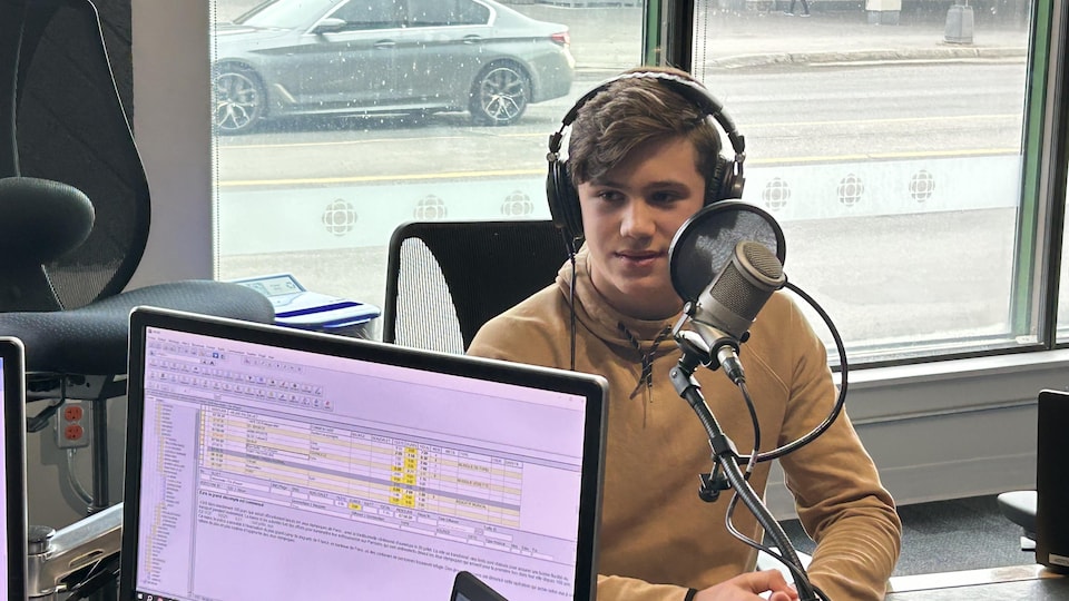 Zavier Simard, jeune élève d'école secondaire, est assis devant un micro du studio de Radio-Canada à Sudbury.