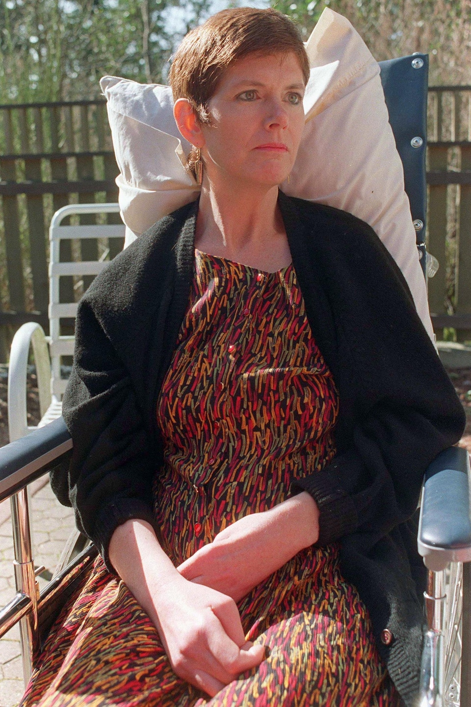 Sue Rodriguez assise dans la cour ensoleillée de sa résidence de Saanich, en Colombie-Britannique, en 1993. 