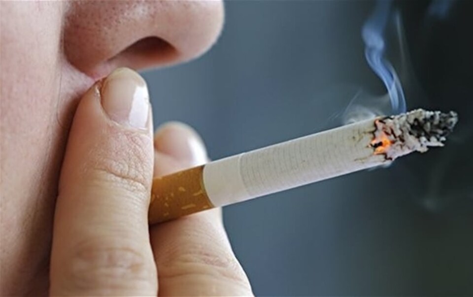 Une femme fume une cigarette 