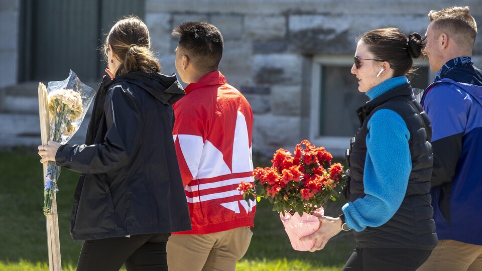 The young people are carrying flowers.