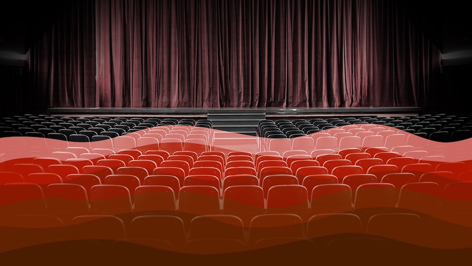 Une salle de spectacle vide avec une illustration d'une vague rouge qui couvre une partie des sièges.