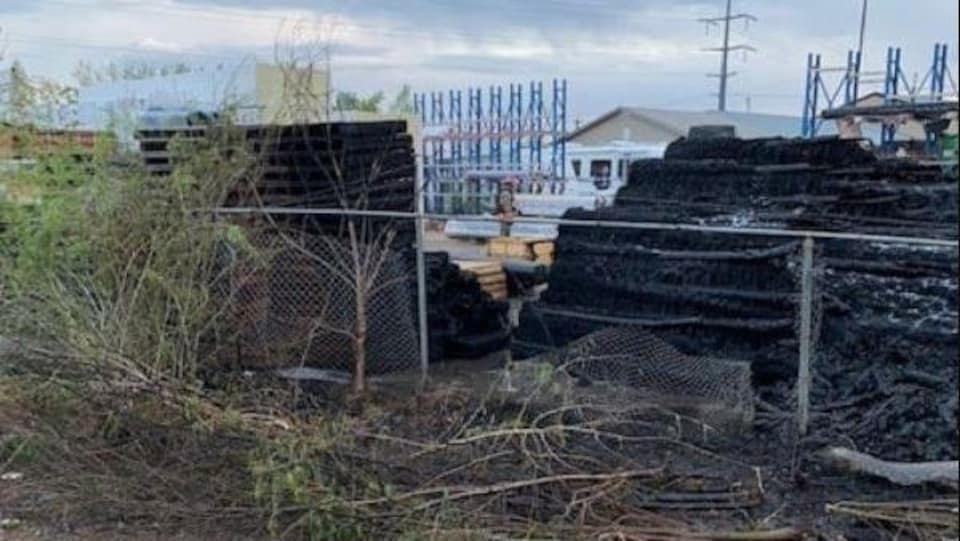 Wooden pallets were damaged by fire, a fence was damaged and trees were on the ground in the yard of a business in Saskatoon.
