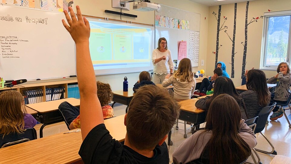 Chantal Côté A sixth grader raises her hand while giving her financial literacy workshop.