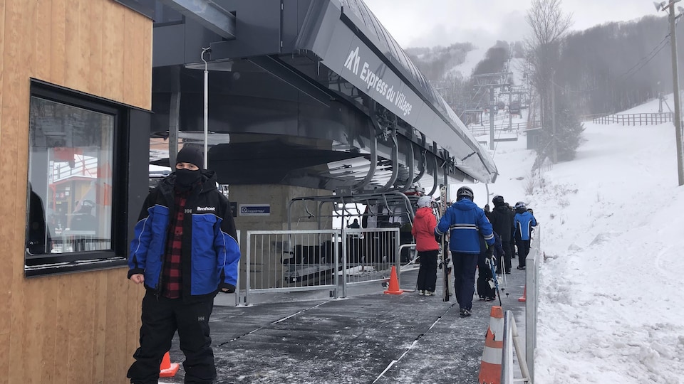 Des skieurs en attente à un remonte-pente.