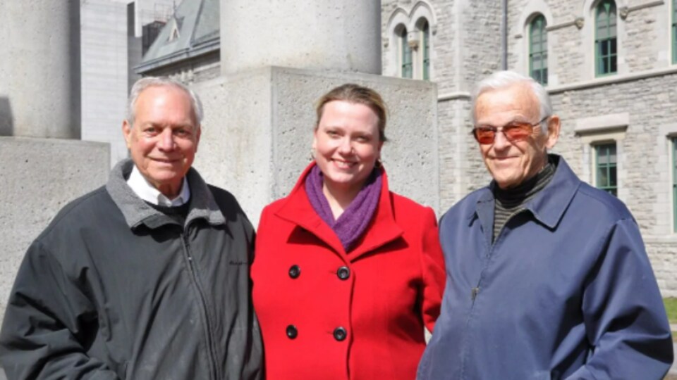 Left to right, Rutherford, Evans and George Wilkes pose in front of the sculpture on Elgin Street.