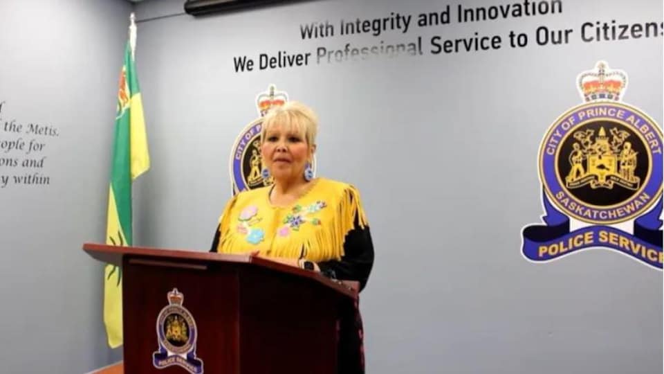Metis-Nation Saskatchewan Regional Director Sherry McLennan behind a podium. 