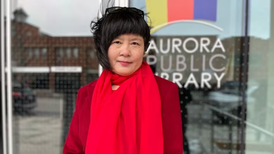 Yafang Shi devant la bibliothèque d'Aurora.