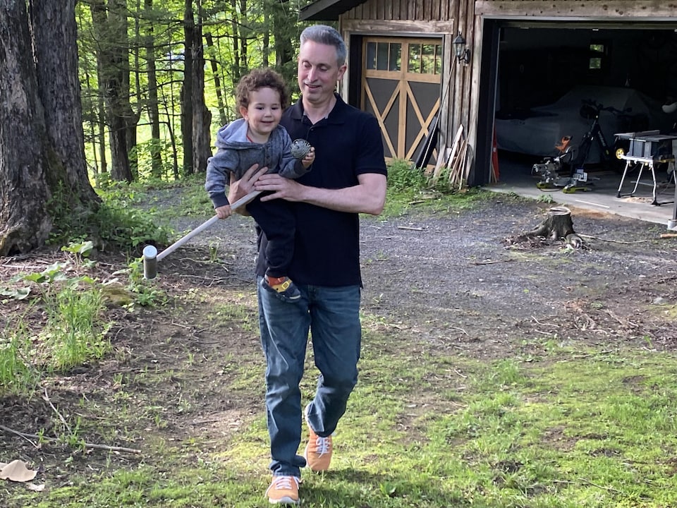 Jonathan Sommer is holding Marat, a young boy. 