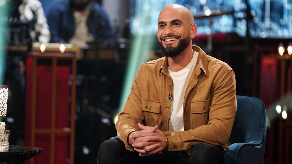 A seated man smiled.