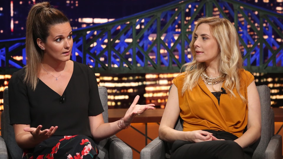 Monique is wearing a black blouse and floral pants. Emilie was wearing black pants and an ocher blouse.