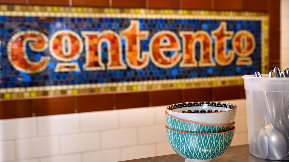 Sur le mur est inscrit en mosaïque le nom du restaurant Contento.